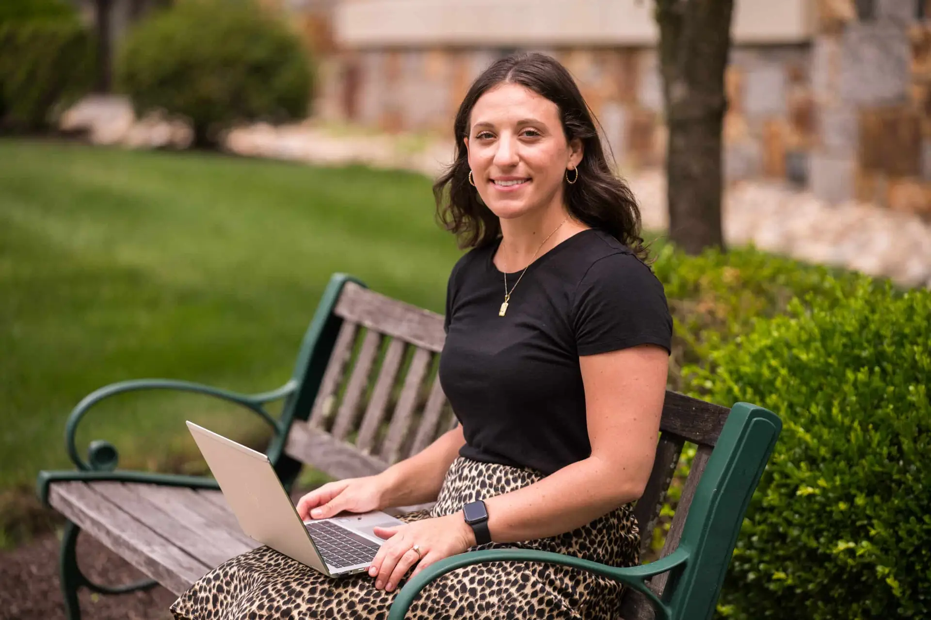 woman sitting and using a laptop