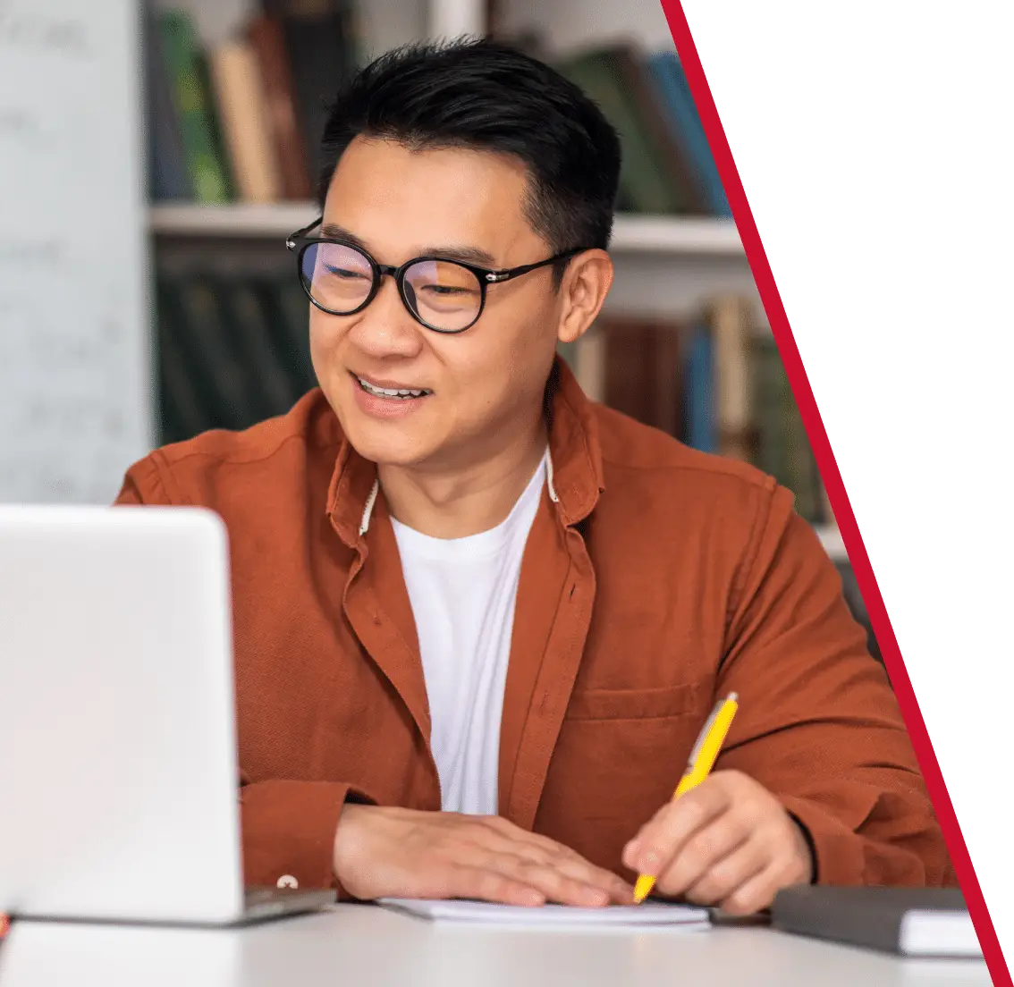 man sitting and using a laptop